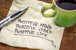 Positive verse on napkin with coffee