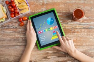 Reading about a food health app on tablet