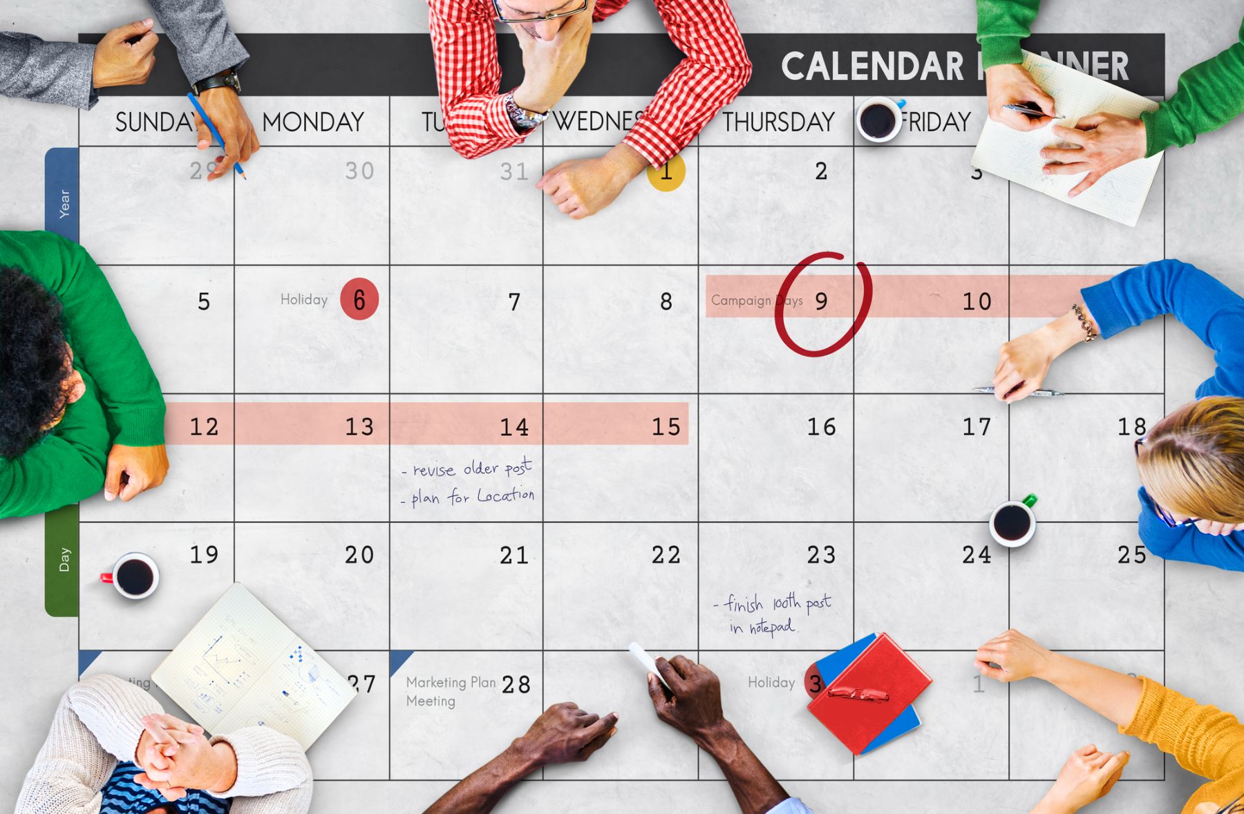 Coworkers discussing dates on a calendar