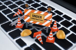 Keyboard has under construction sign with caution cones on the keys
