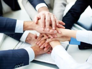 Hands piled on top of another