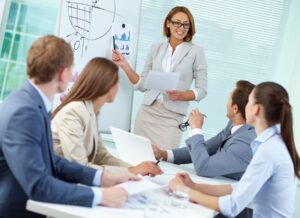 Employees in a meeting looking at a graph