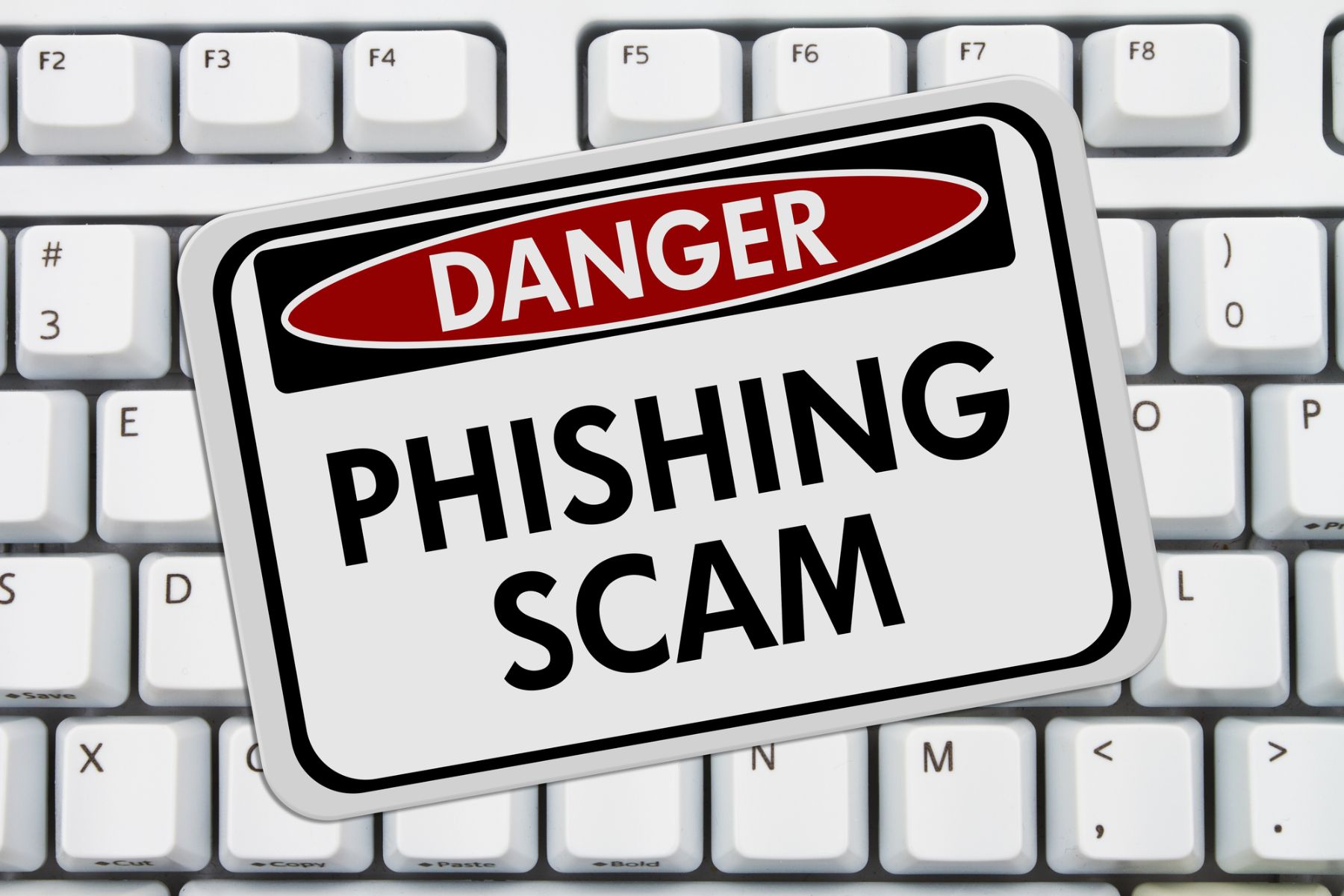 Danger Phishing Scam sign on keyboard