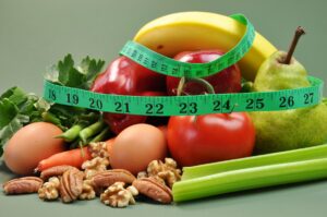 a pile of healthy food with a measuring tape on top