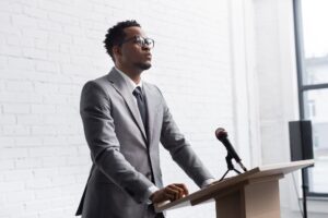 a guy standing in front of podium giving a speech