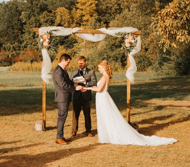 couple standing under an arch getting married