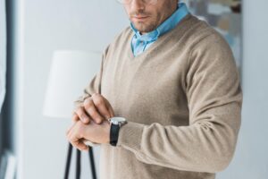 Man looking a wrist watch, Reclaiming Time