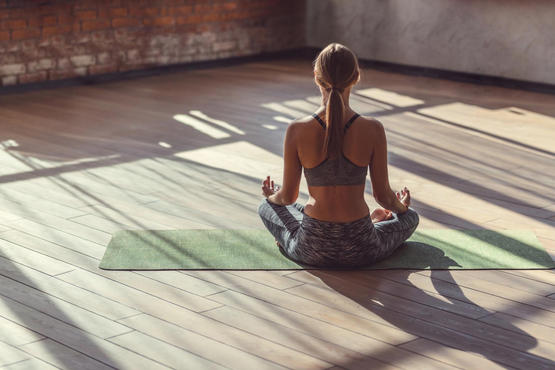 woman sitting in Yoga pose